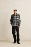 Man wearing a plaid shirt and cap against a plain background Rhythm Alex Check LS Shirt - Forest