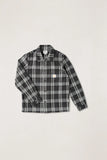 A long-sleeve plaid button-up shirt in black and white, featuring a small Carhartt logo patch on the left chest, laid flat against a light gray background. Rhythm Alex Check LS Shirt - Forest