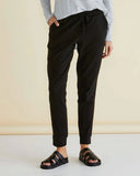 Person wearing black jogger pants and a striped shirt on a beige background Betty Basics Heidi Pant - Black