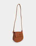 Brown leather handbag with a strap on a light gray background