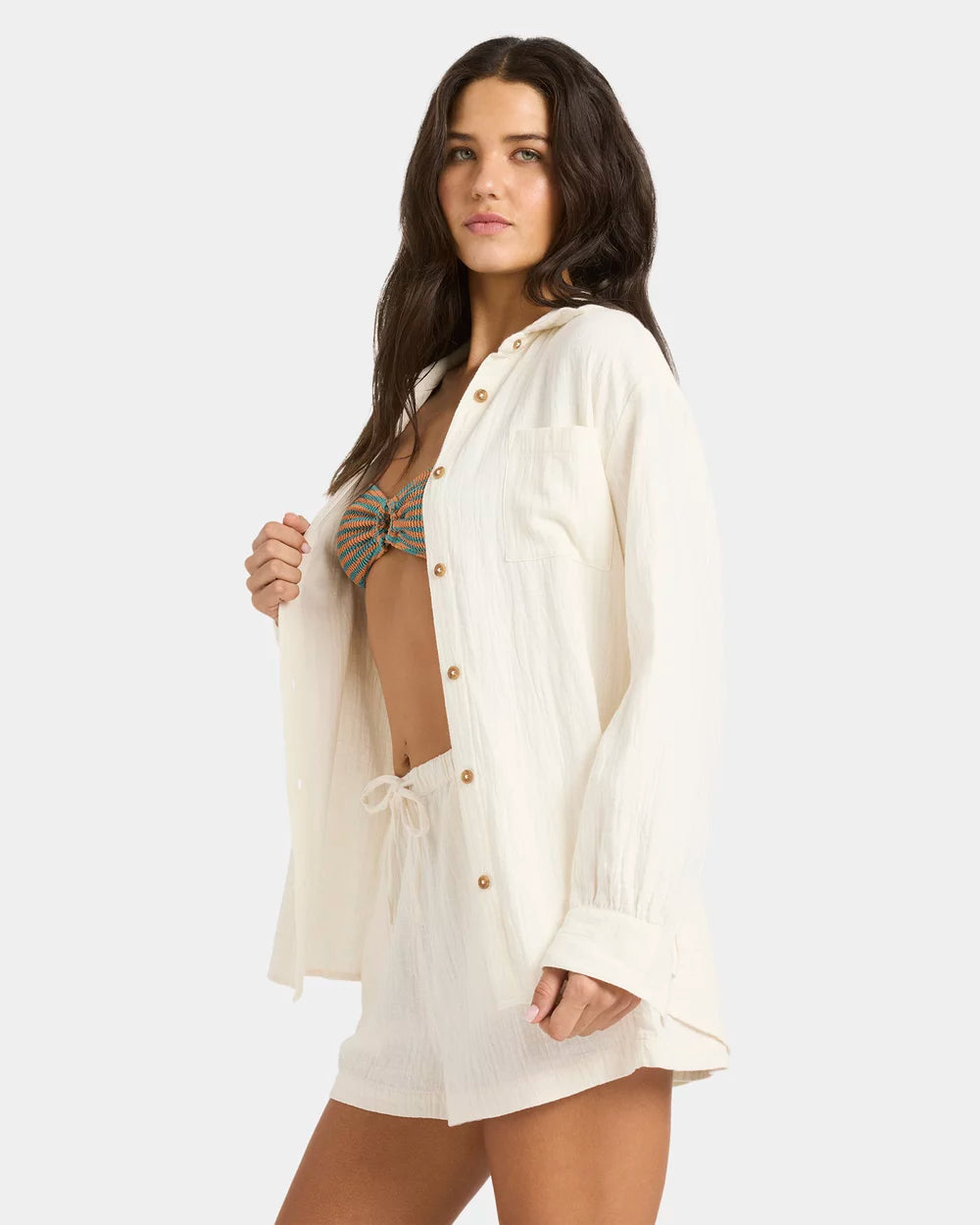 Woman wearing a white cover-up over a bikini on a plain background Billabong Wanderer LS Woven Top - Salt Crystal
