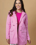 Woman wearing a pink raincoat against a beige background Charlo Fran Jacket - Pink