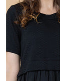 Black textured top worn by a person with brown hair. Charlo Greta Dress - Black