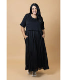 Woman wearing a black outfit against a beige background Charlo Greta Dress - Black