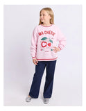 Young girl wearing a pink sweatshirt with text and graphics, standing against a white background Eve Girl Cherry Hearts Crew - Pale Pink