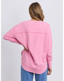 Person wearing a pink Foxwood Delilah Crew sweatshirt with a plain background