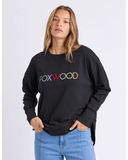 Woman wearing a black sweatshirt with 'FOXWOOD' in colorful letters on a white background