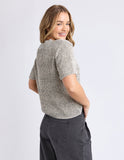 Woman wearing a textured knit shirt and dark pants on a light gray background Foxwood Davana Knit - Oat Marle