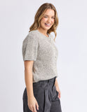 Woman wearing a textured knit top and dark pants on a light gray background Foxwood Davana Knit - Oat Marle