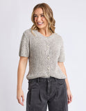 Woman wearing a textured short-sleeve top and dark pants on a light background Foxwood Davana Knit - Oat Marle