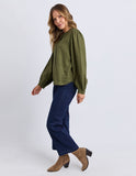 Woman wearing a green top and blue jeans on a white background Foxwood Eleanor Top - Winter Moss