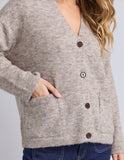 Close-up of a person wearing a gray cardigan with buttons on a light gray background Foxwood Emarie Cardi - Oatmeal