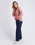 Woman wearing a pink sweater and blue jeans on a white background Foxwood Emarie Cardi - Woodrose