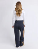 Woman wearing navy pants with a beige stripe on a white background Foxwood Juno Pant - Ink