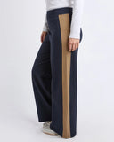 Navy pants with a brown stripe worn by a person on a white background Foxwood Juno Pant - Ink