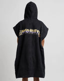 A person shown from the back wearing a black hooded poncho-style garment with a large multicolor graphic reading 'THE MAD HUEY' across the upper back, against a plain light gray studio background.