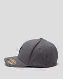 A dark gray structured baseball cap with a curved brim, shown from a side profile on a light gray background. A circular gold and black sticker is visible on the brim.