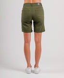 A pair of women's khaki-colored Mi Moso Cali shorts, showing the back view with pockets on the legs. The model is wearing white sneakers.