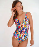 A model wearing a multicolored geometric patterned one-piece swimsuit with a V-neck.