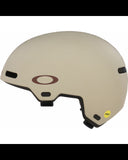 Side profile view of the Matte Sand Oakley ST1 helmet displaying the cooling ventilation channels and adjustable chin strap.