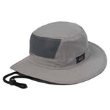 A gray wide-brim bucket hat with a black mesh back panel and a black chin strap, shown on a plain white background. A small black brand patch is visible on the side of the crown.

 Front view of the Hurley Phantom Voyager Boonie Hat in Wolf Grey showing the wide protective brim and icon branding.