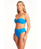 This image features the Sea Level Honeycomb Retro High Waist Bikini Pant in a striking Capri blue color. The bikini pant is designed with a textured, honeycomb pattern that provides a light, waffle-like feel.