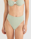 A model wearing a two-piece bikini with a green and white gingham check pattern, featuring a bandeau-style top with a front bow and high-waisted bottoms. Rhythm Lola Check Hi Waist bikini Pant - Green