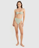 A woman modeling a two-piece bikini with a green and white gingham pattern, featuring a bandeau-style top with a small front bow and high-waisted bottoms, set against a plain light gray background. Rhythm Lola Check Hi Waist bikini Pant - Green