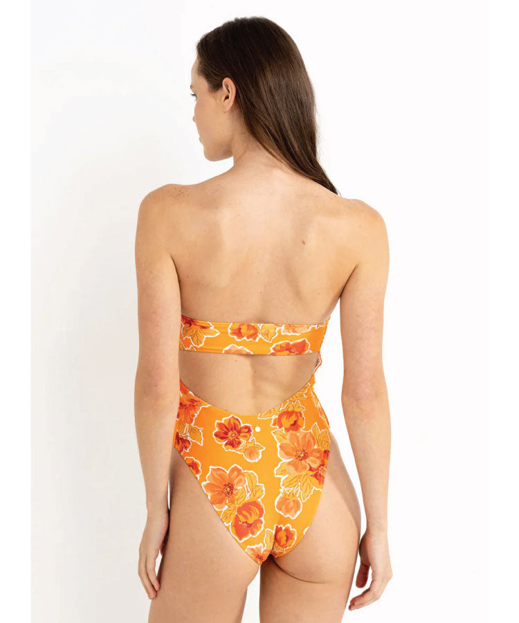 Back View of model wearing the Rhythm Ayla Floral Strapless One Piece - Orange. Woman wearing an orange floral bikini on a white background
