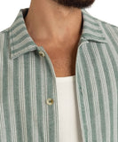Close-up of a person wearing a green and white striped shirt over a white t-shirt. Rhythm Butcher Stripe Relaxed SS Shirt - Teal