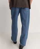 Person wearing blue jeans on a plain background Rhythm Essential Jean - Dark Blue