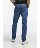 Person wearing blue jeans on a white background Riders R3 Narrow Magnitude Jeans