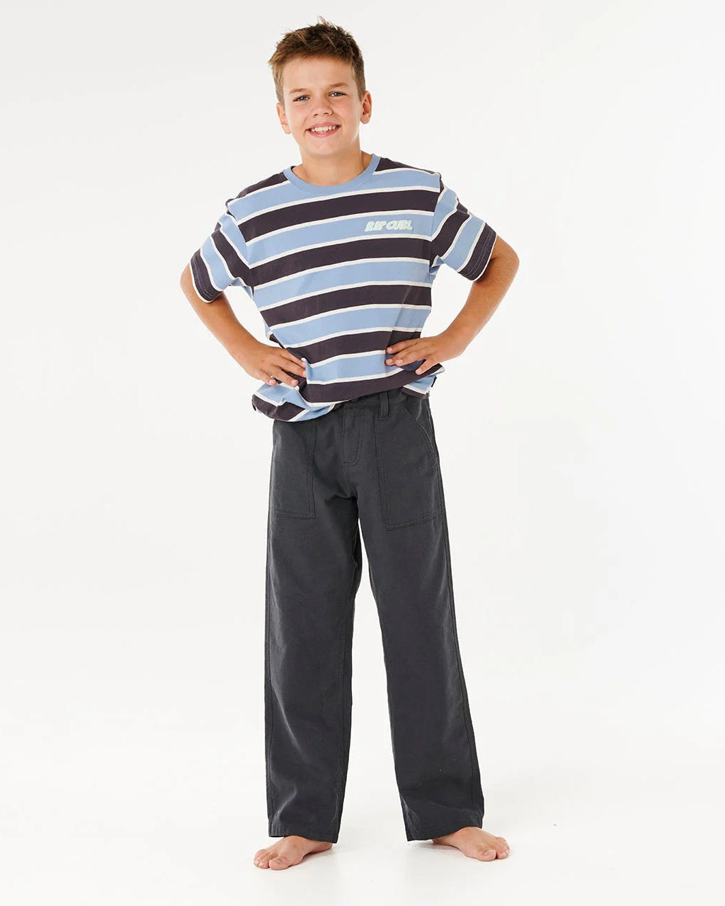 Child wearing a striped shirt and dark pants on a white background Rip Curl Hyped Canvas Boys Pants - Washed Black