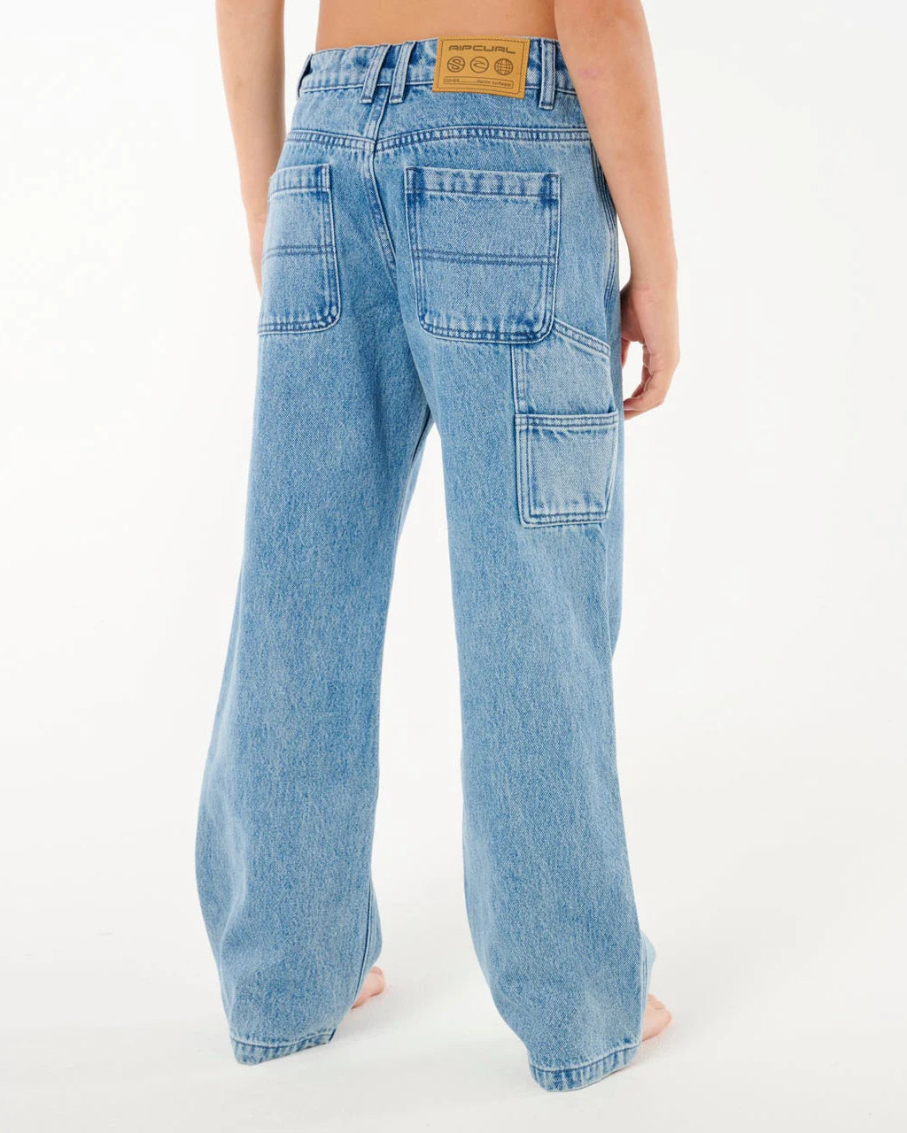 Light blue jeans worn by a person on a white background Rip Curl Hyped Denim Boys Pants - Washed Blue