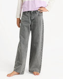 Person wearing gray wide-leg jeans on a white background. 
