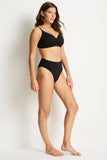 Woman wearing a black bikini against a plain background
