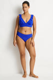 Woman wearing a blue bikini against a white background
