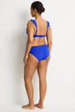 Woman wearing a blue bikini against a white background