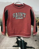 Red sweatshirt with 'SAINT Gobain' text on a hanger against a blurred outdoor background