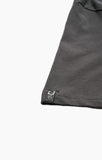 Close-up of a gray fabric edge with a brand label on a white background Salty Crew Trout Mount Premium SS Tee - Coal