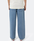 Person wearing blue jeans and a white shirt on a white background Santa Cruz Yelling Stack Baggy Denim Jeans - Mid Blue Denim