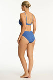 Woman wearing a blue bikini on a white background