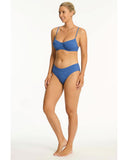 Woman wearing a blue bikini on a white background