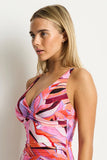 Close-up detail of the cross-front wrap design, peekaboo keyhole, and flattering ruched bodice texture on the Berry togs.