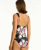 Model wearing Sea Level Belle Frill One Piece - Black showing it from the back view.