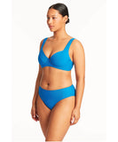 This image features the Sea Level Honeycomb Mid Bikini Pant in a striking Capri blue color. The bikini pant is designed with a textured, light waffle fabric that offers both comfort and style, highlighted by its mid-rise waist and smooth, soft fit.
