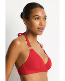 Woman wearing a red bikini top with gold accents on a white background