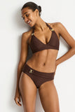Woman wearing a brown bikini against a white background