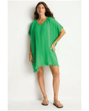 Woman wearing the Sea Level Sunset Kaftan - Kelly Green against a white background