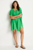Woman wearing the Sea Level Sunset Kaftan - Kelly Green with a white background